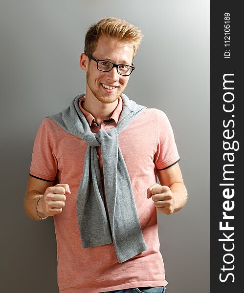 Handsome young blonde man on grey background. Handsome young blonde man on grey background.