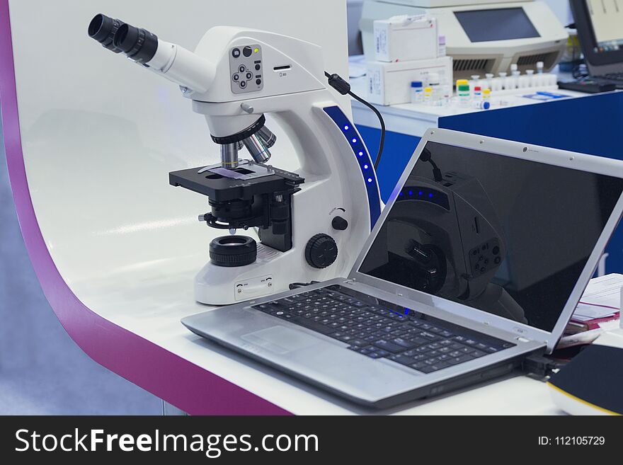 Microscope and a laptop in a medical laboratory