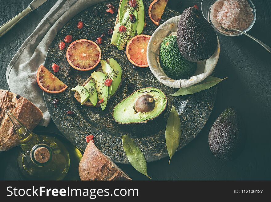 Toast with avocado and oil. Bread with avocado. Concept of healthy food. Dark background