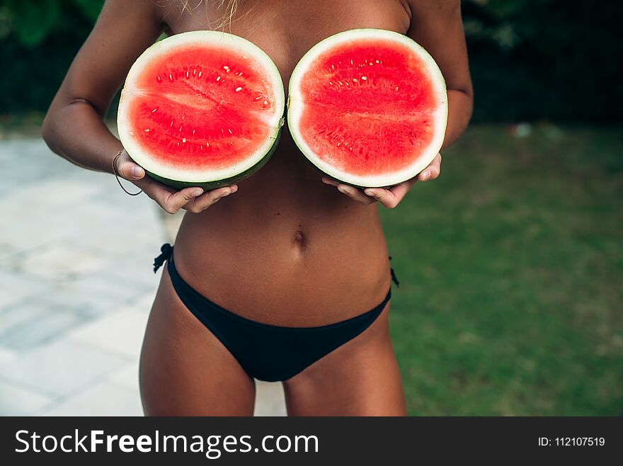 Close Up Girl Hands Holding Red Watermelon Cover Her Breast. Model With Perfect Body. Concept Of Sport, Vegetarian