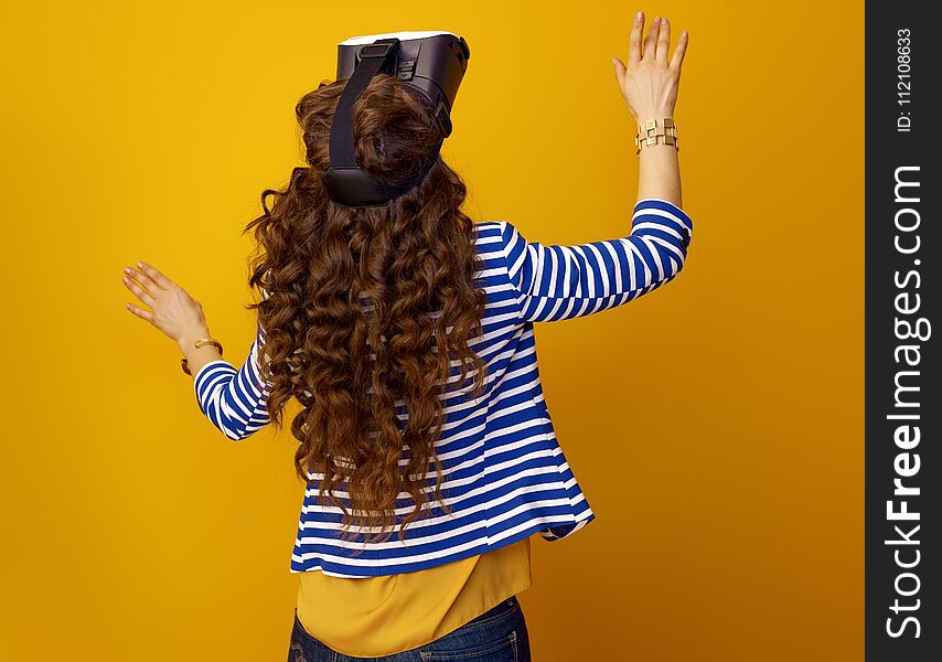 Trendy Woman On Yellow Background Using VR Headset