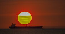Setting Sun Behind A Ship - Sunset Over The Ocean Curacao Views Royalty Free Stock Photos