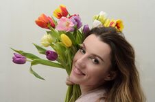 Young Charming Girl With A Bouquet Of Flowers - Multi-colored Tulips Stock Images