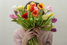 Young Charming Girl With A Bouquet Of Flowers - Multi-colored Tulips Royalty Free Stock Photos