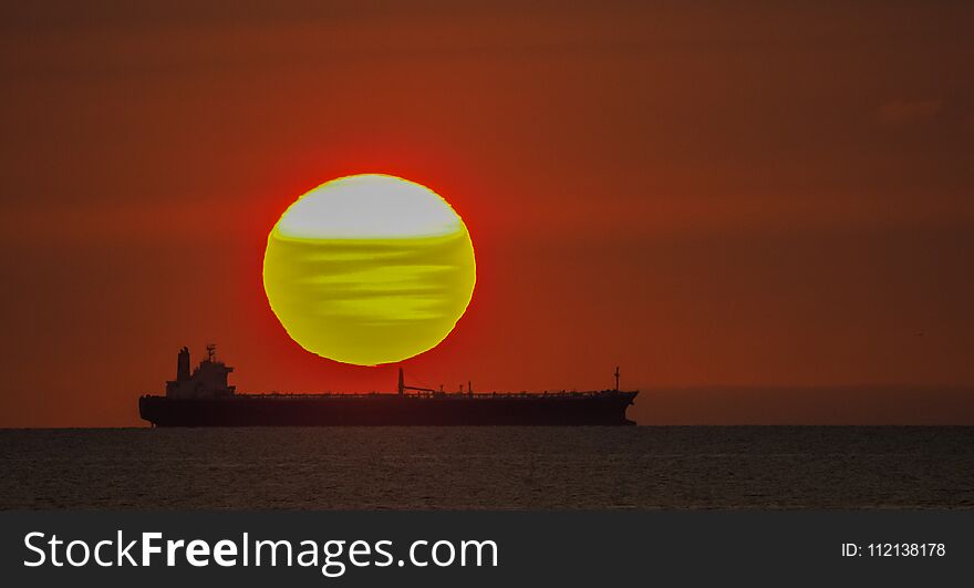 Setting Sun Behind A Ship - Sunset Over The Ocean Curacao Views