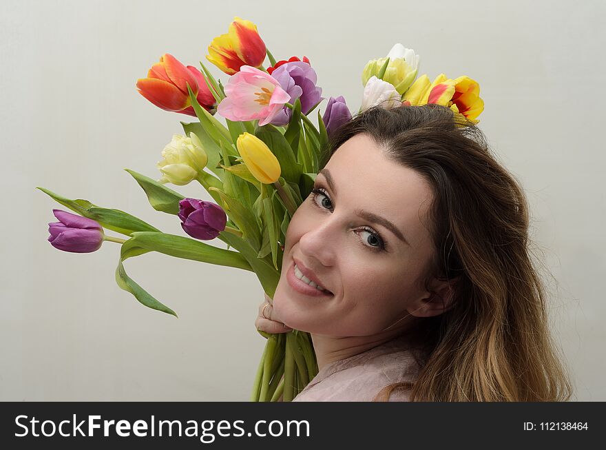 Young Charming Girl With A Bouquet Of Flowers - Multi-colored Tulips