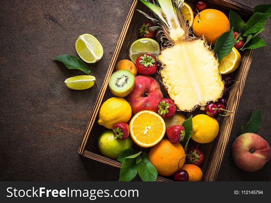 Fruit And Berries Over Dark Stone Table.