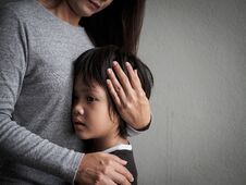 Sad Little Boy Being Hugged By His Mother At Home. Stock Images