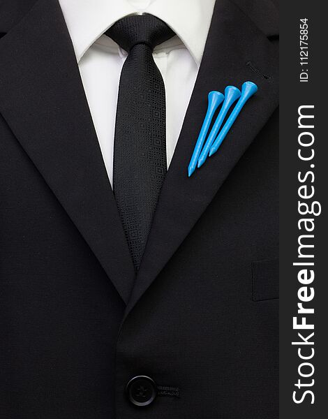 The detail of wedding suit with golf design. Blue golf tees on the flap of black jacket.