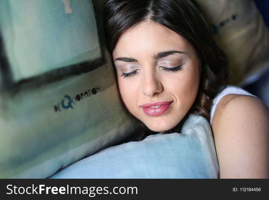 Woman Sleeping While Holding Pillow