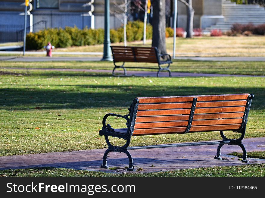 Black Metal Framed Brown Wooden Bench On Park