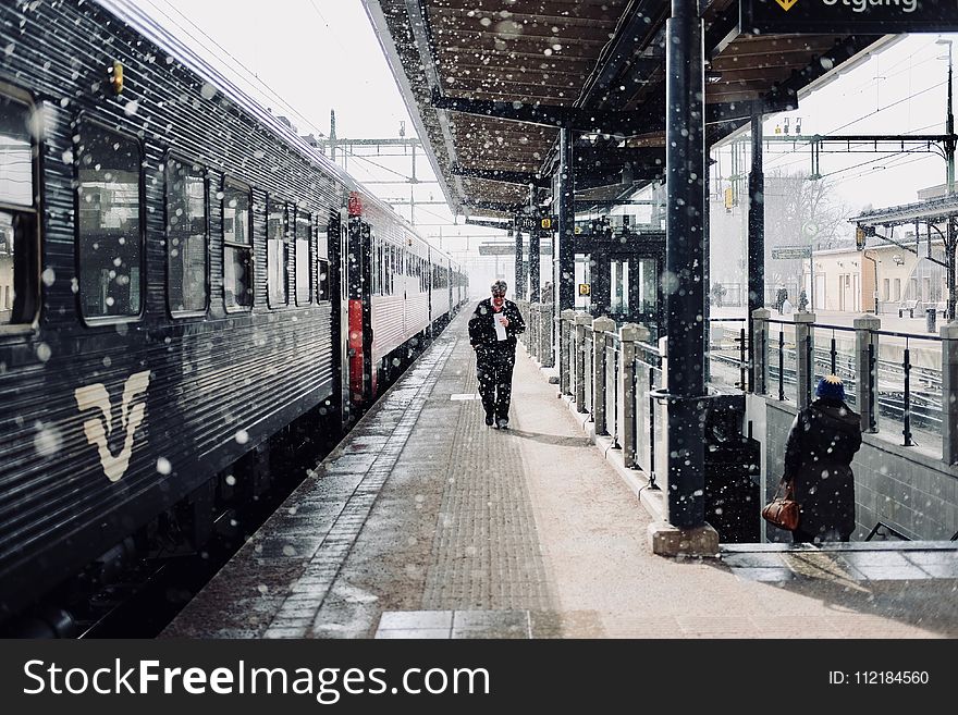 Man Walks Beside Train