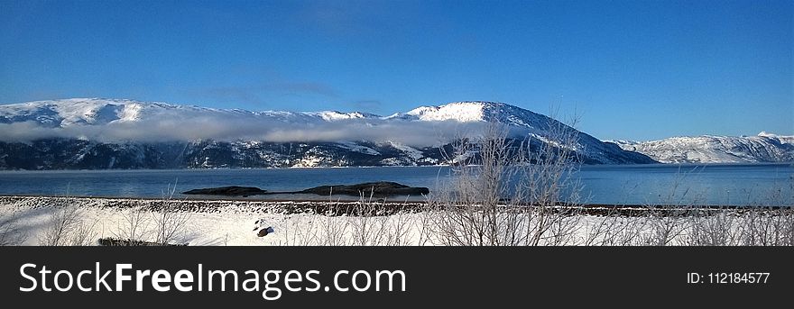 Mountain Coated With Snow Under Blue Sky