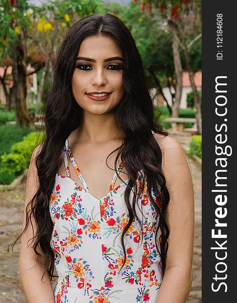 Woman Wearing White and Multicolored Floral Sleeveless Top