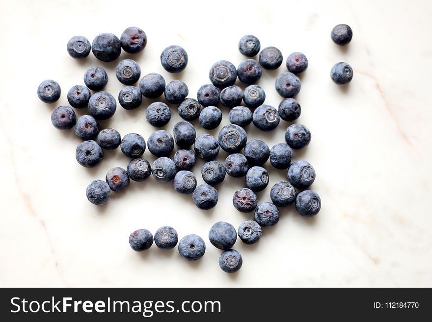 Photo of Black Berries on White Surface