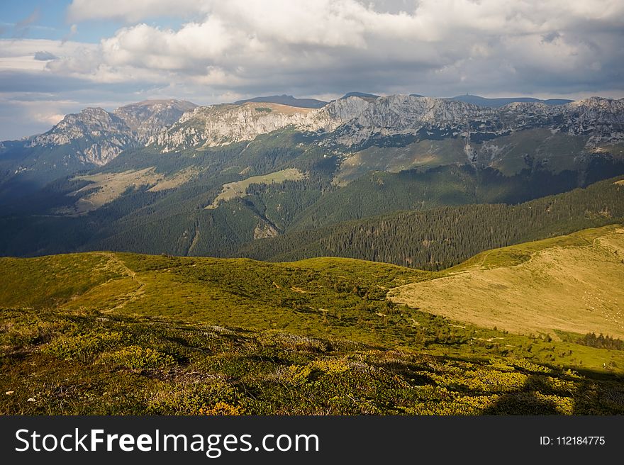 Green Mountain Range Under Cloudy Skies