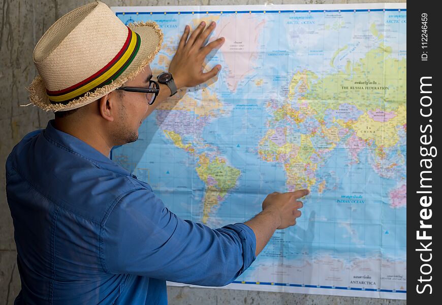 Tourist pointing at worldmap for next destination, lifestyle concept.