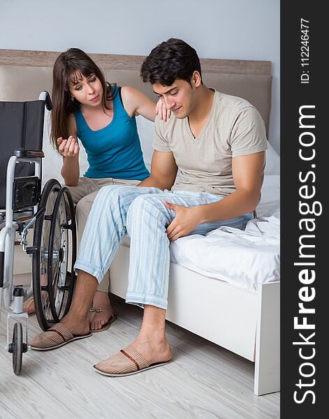 Desperate men on wheelchair with his sad wife. Desperate men on wheelchair with his sad wife