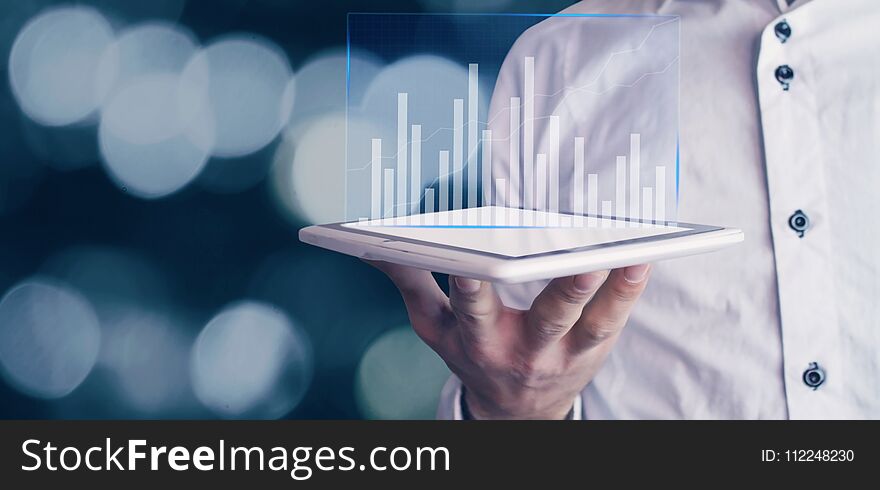 Businessman holding graph in the tablet. Finance concept. Businessman holding graph in the tablet. Finance concept