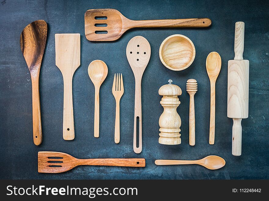 Kitchen utensils with copy space on black stone background