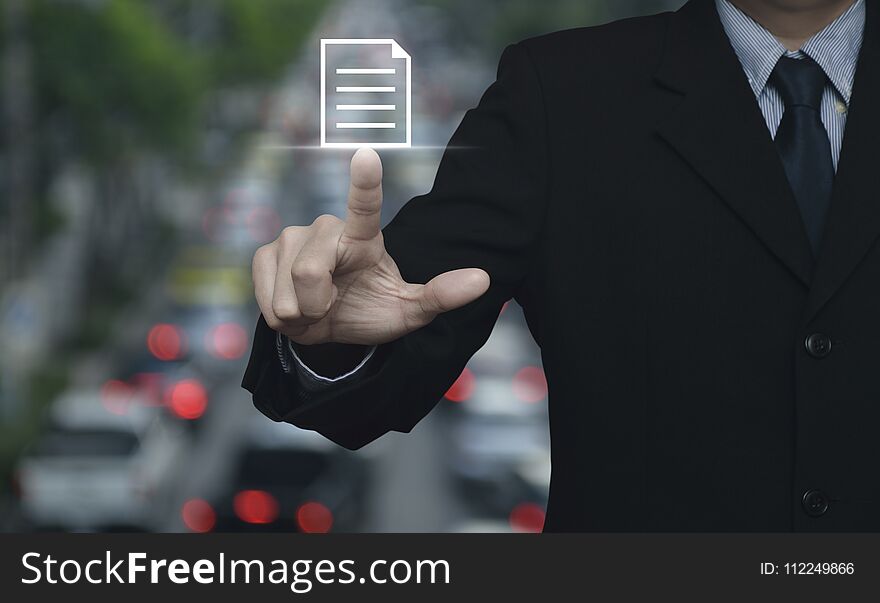 Businessman pressing document icon over blur of rush hour with cars and road, Business communication concept