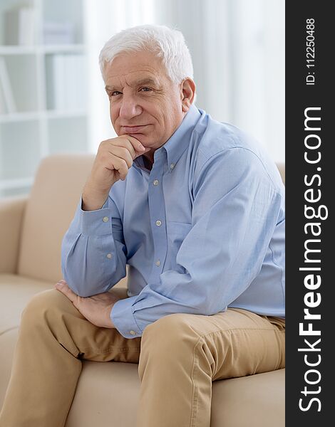 Portrait of pensive senior man resting on sofa. Portrait of pensive senior man resting on sofa