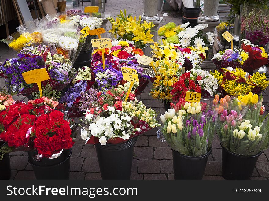 Flowers in a florist shop outdoors floor ready to be sold with a variety of pots with plants and prices in signets. Flowers in a florist shop outdoors floor ready to be sold with a variety of pots with plants and prices in signets.