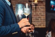 Man In A Blue Suit Holds Glass Of White Wine Royalty Free Stock Photography Man In A Blue Suit Holds Glass Of White Wine Royalty Free Stock Photography