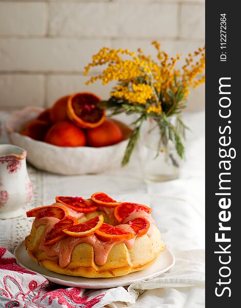 BLOOD ORANGE POUND CAKE WITH AN ORANGE ZEST ICING..vintage style.selective focus