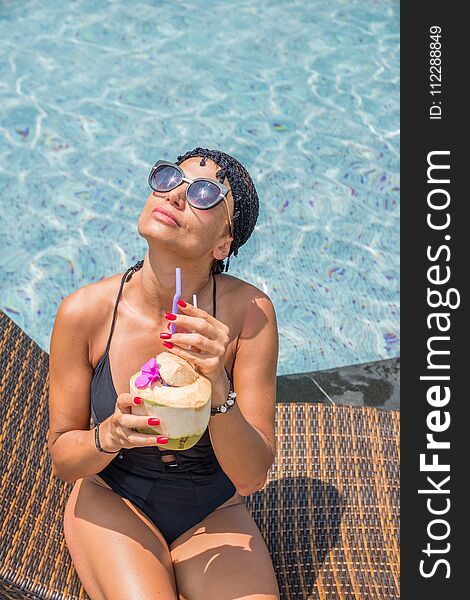 Beautiful woman enjoying summer and tanning at the pool. Beautiful woman enjoying summer and tanning at the pool