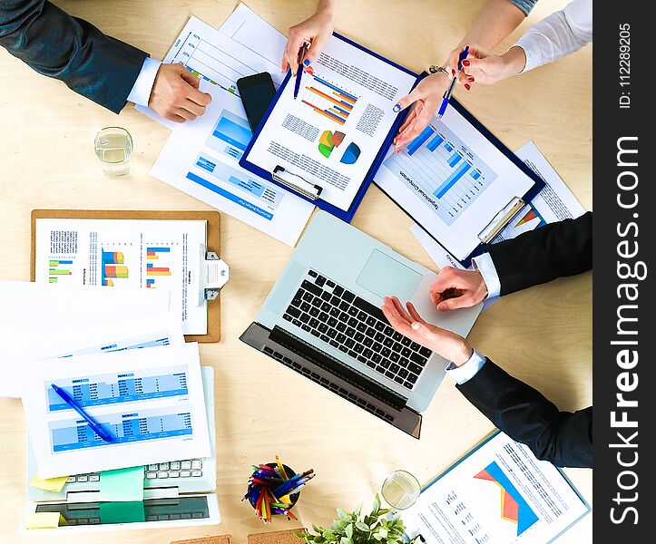 Business People Sitting And Discussing At Business Meeting, In Office