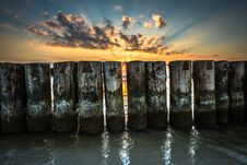 Sunset On Beach With A Wooden Breakwater In Leba, Baltic Sea, Po Royalty Free Stock Photo