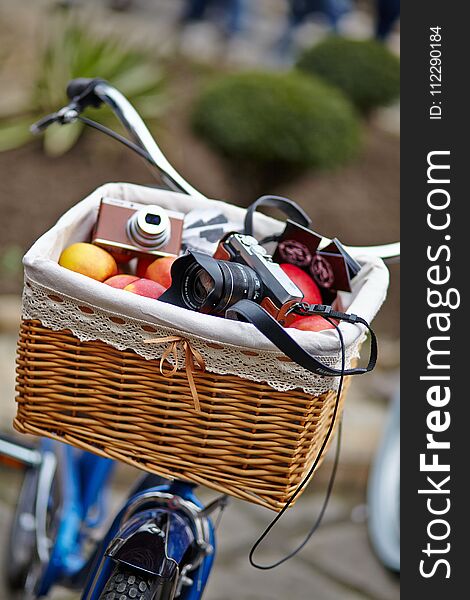 Basket with a camera and fruit.