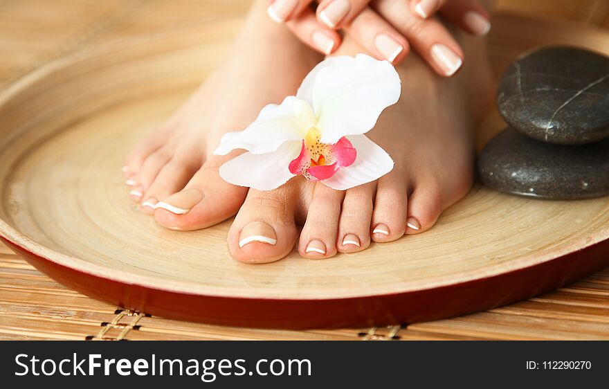 Care for beautiful woman legs with flower .