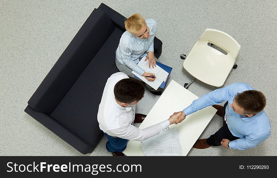 Business people sitting and discussing at business meeting, in office.