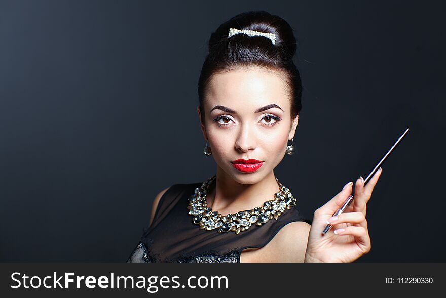 Portrait of young beautiful woman with jewelry .