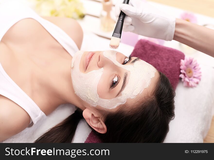 Woman with mask on her face having head massage.