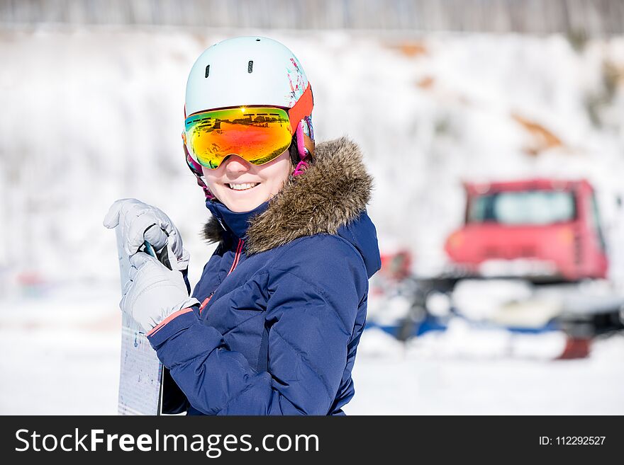 Portrait of female athlete in mask and helmet on blurred snowy day background. Portrait of female athlete in mask and helmet on blurred snowy day background