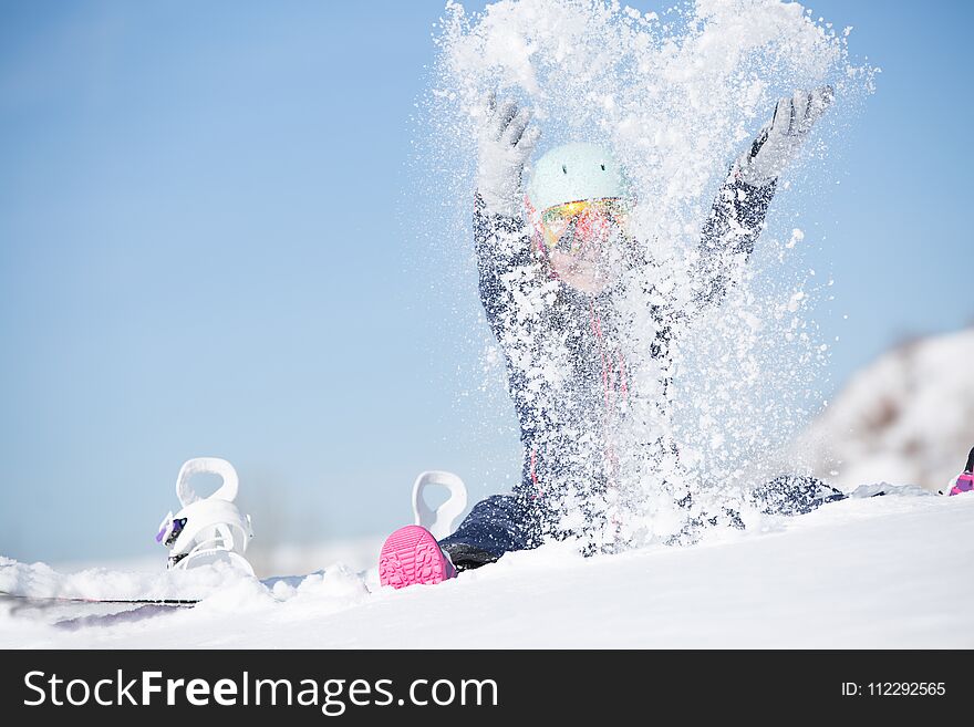Image of sports woman sitting in snowdrift, snow-throwing in winter