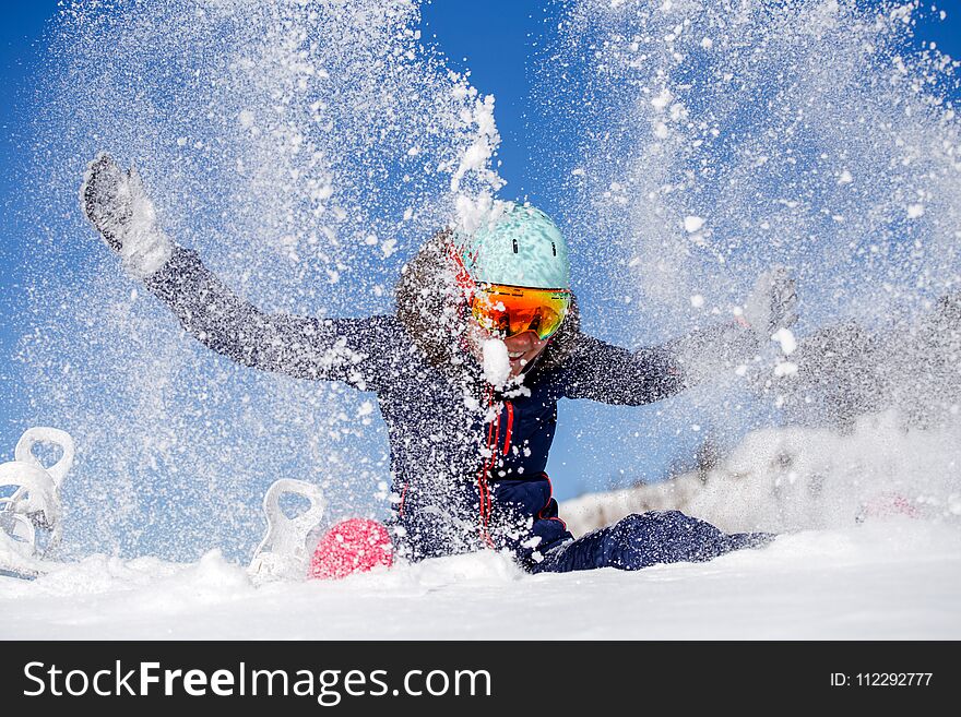 Picture Of Athlete Woman Sitting In Snowdrift , Throws Snow