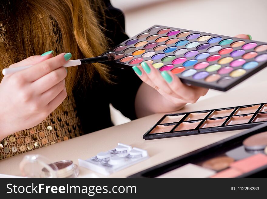 The Young Woman Applying Make-up Preparing For Party