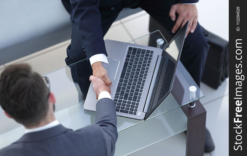 Handshake business people in the workplace.