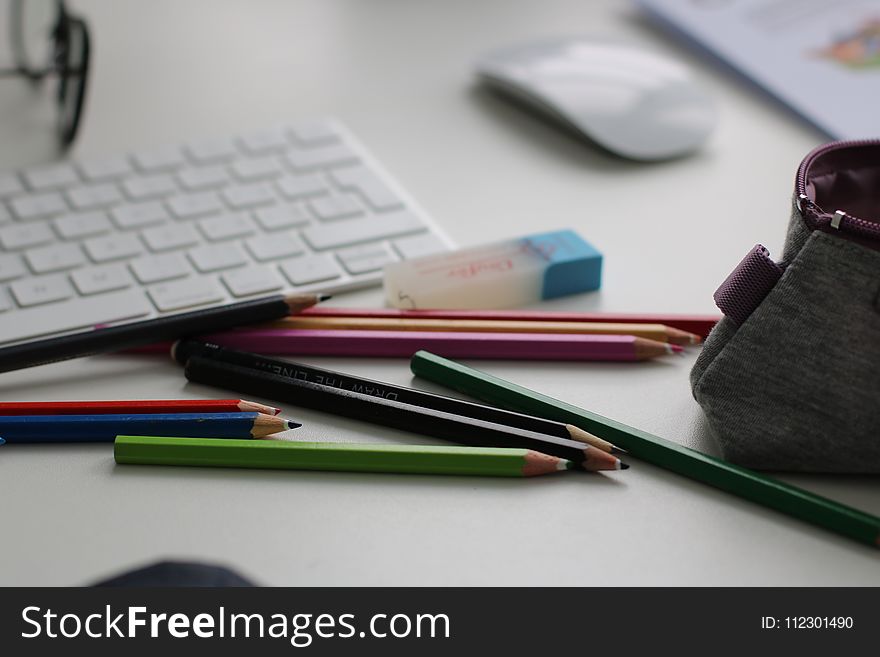 Shallow Focus Photography of Assorted Pencils Near Apple Keyboard and Mouse