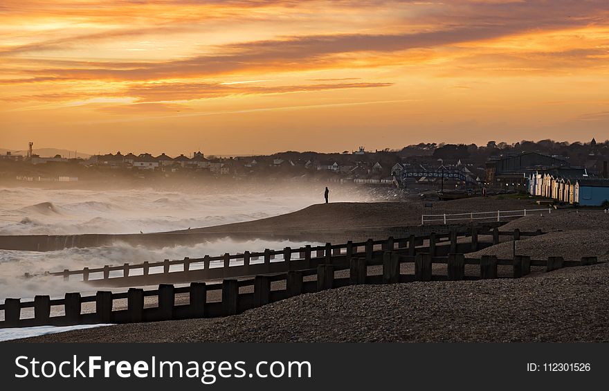 Silhouette of Person in the Middle of Brown Sandy Beach