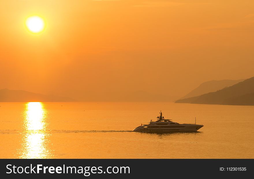 Sailing Cruise Ship during Yellow Sunset