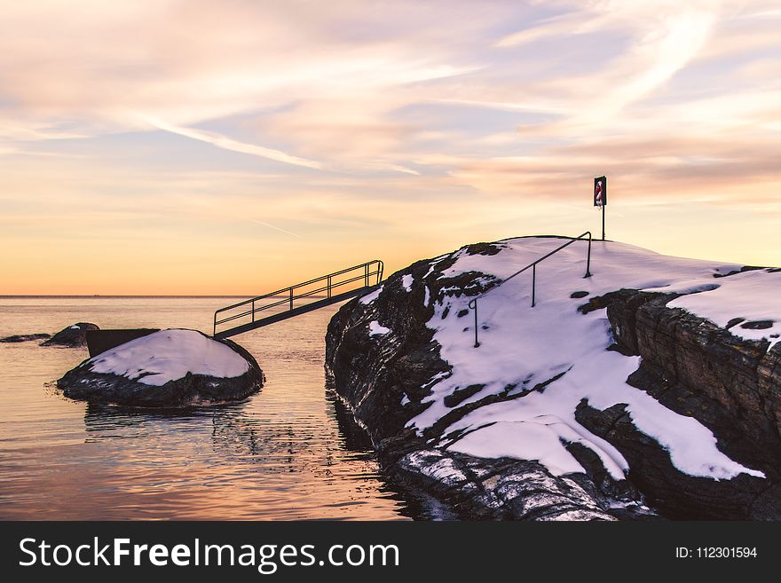 Photo Of Cliff With Bridge And Snow