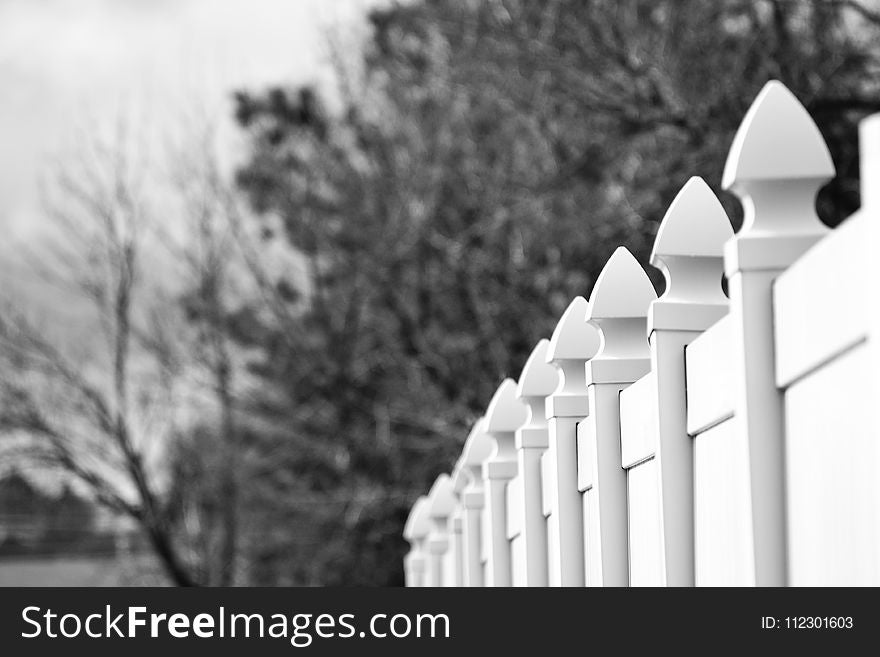 Gray Scale Photo of White Fence