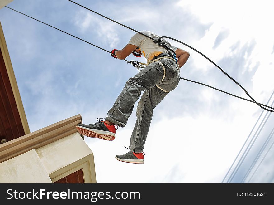 Man Wearing Harness Going Down Building