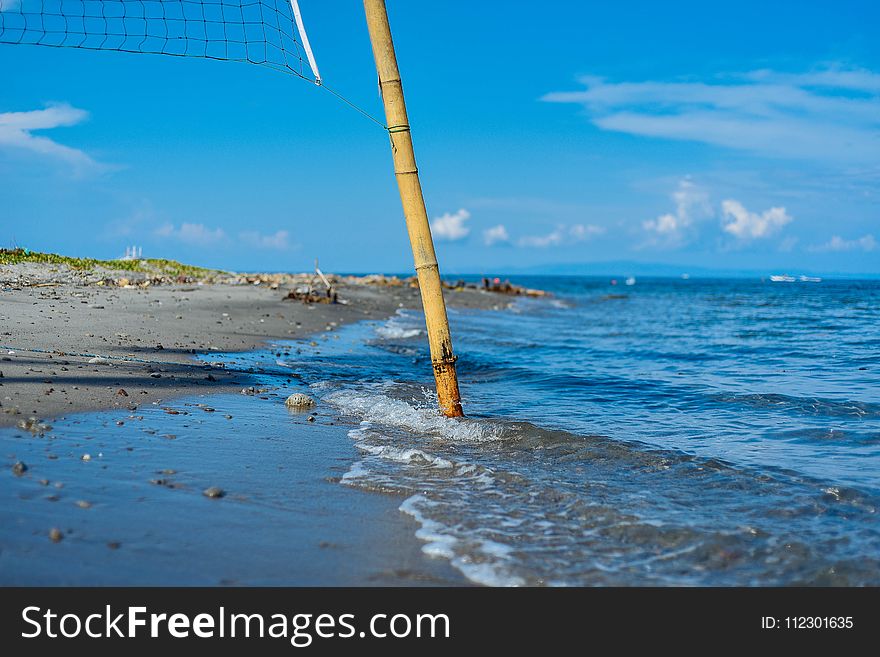 Closeup Photo Of Brown Bamboo Beach Volleyball Post Near Shoreline