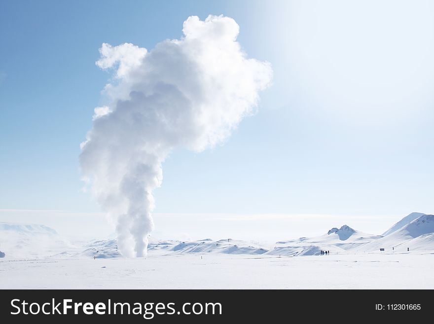 Smoke Rising from Snow-covered Field